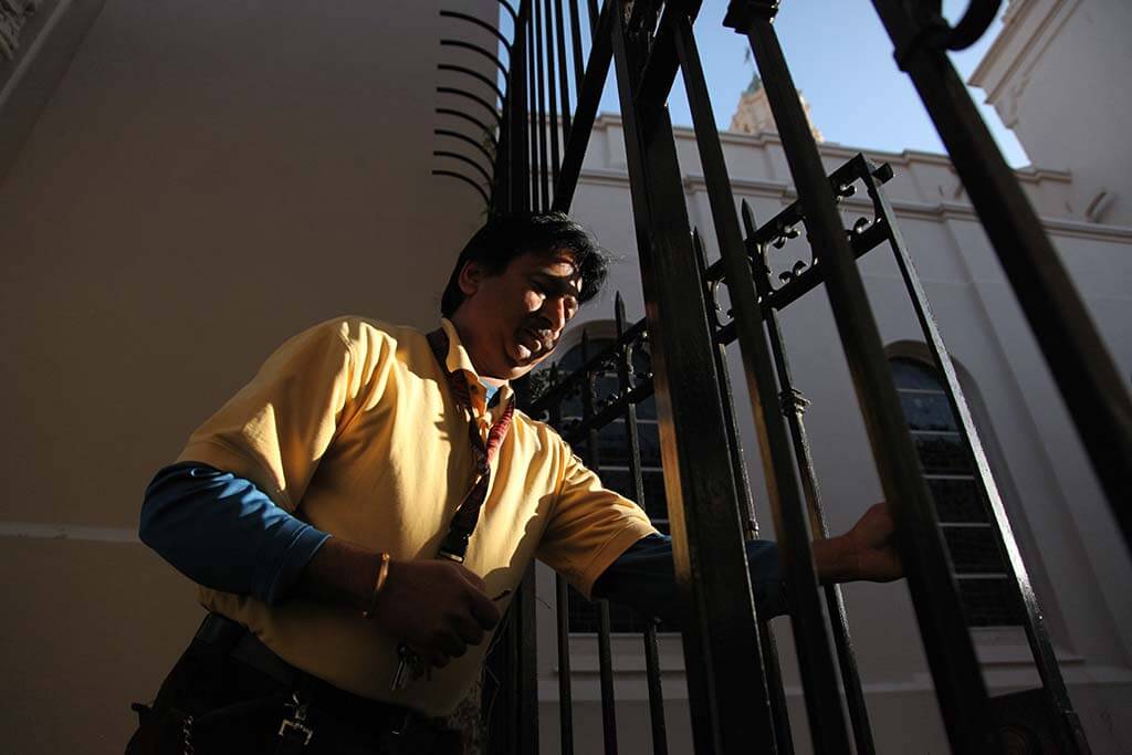 Mission Dolores worker Raju Kumar opens a gate to the church Friday morning