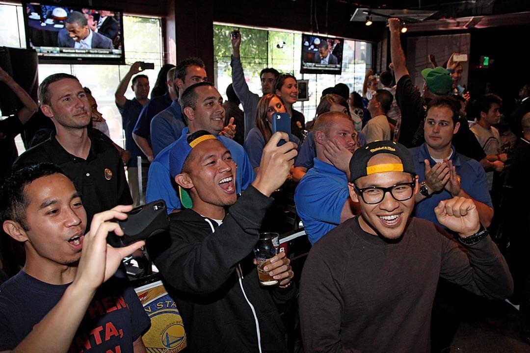 Jesus Caampued Jr., Villiard Corrales and James Lu, of San Jose celebrate with other fans 3000 Broadway in Oakland as the Golden State Warriors announced their selection of Harrison Barnes from the University of North Carolina in the first round of the 2012 NBA draft. (Scot Tucker/SFBay)