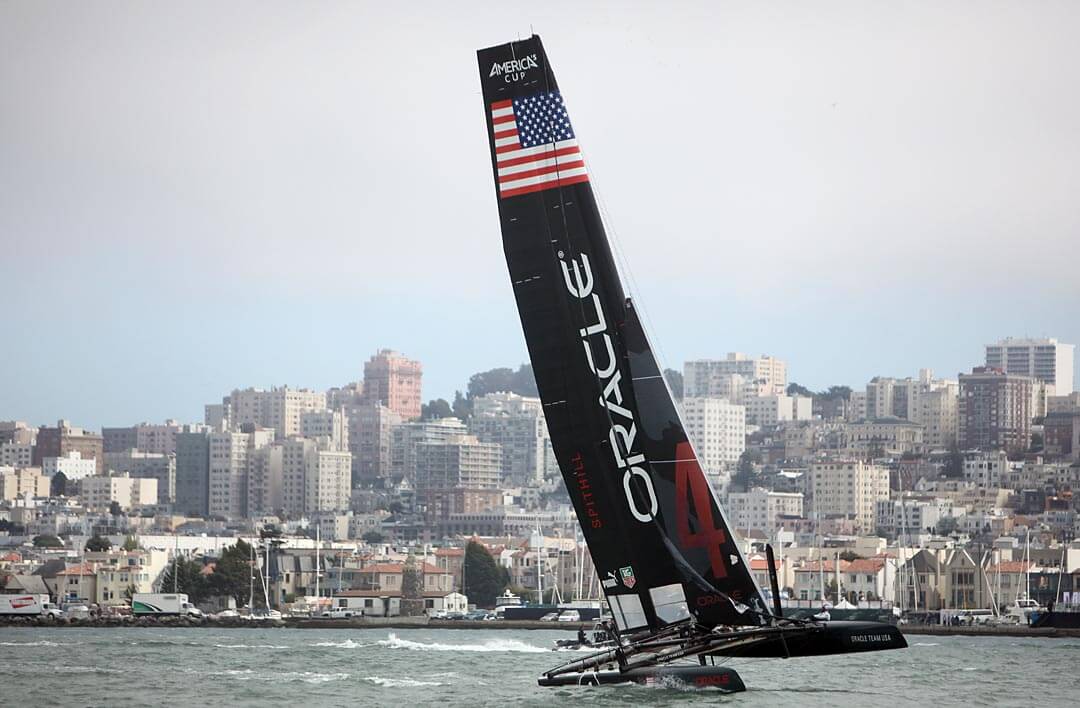 Oracle Team USA glides past the Marina during America's Cup World Series practice in San Francisco on Monday, August 20, 2012